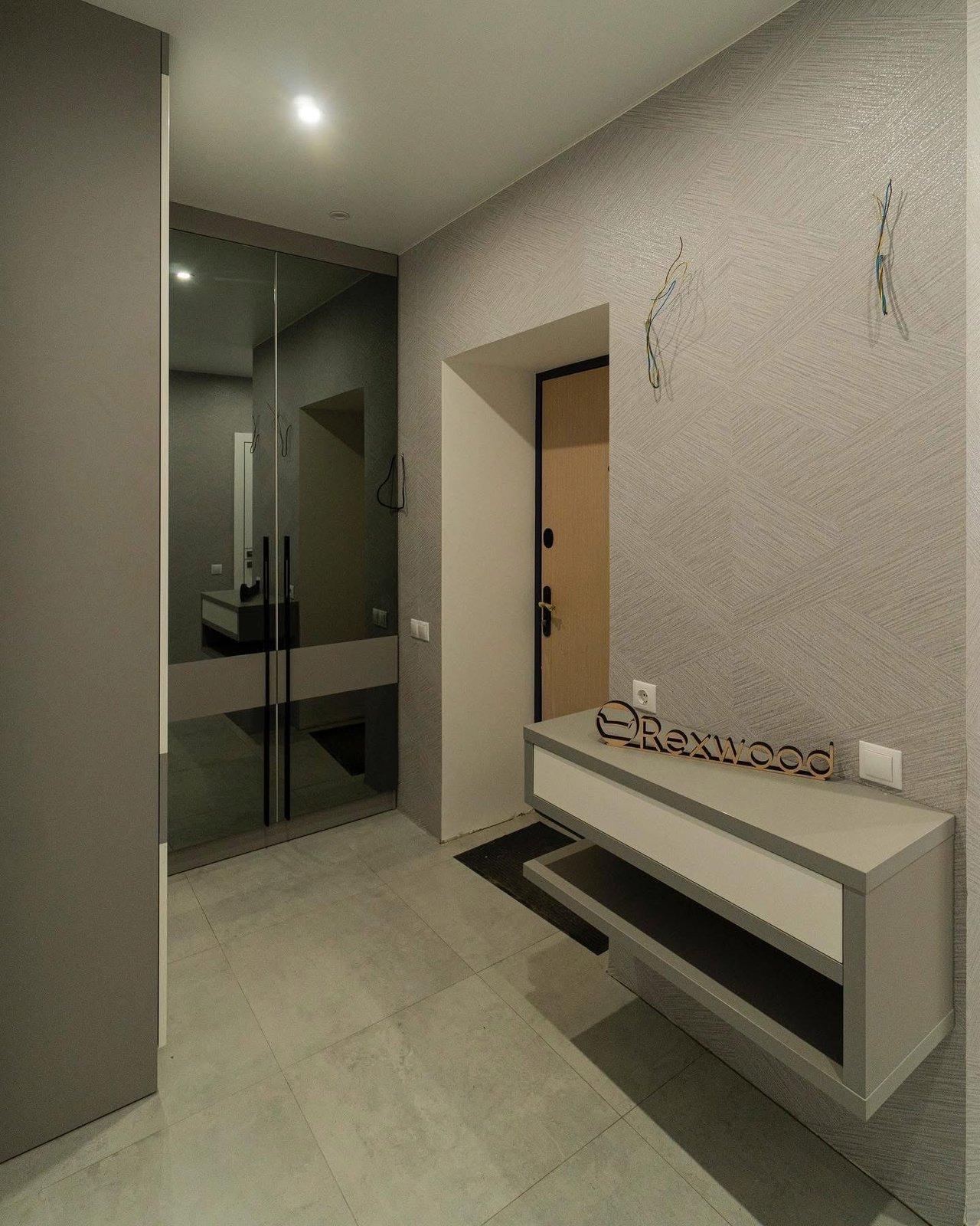 Greige Entryway with Smoked Mirror Wardrobe & Floating Console