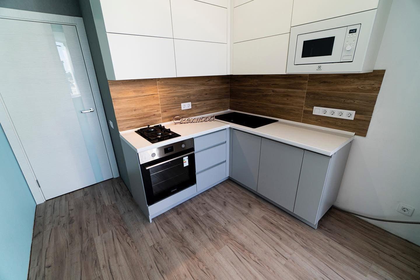 Compact White & Grey Handleless L-Shaped Kitchen with Woodgrain Splashback — 6