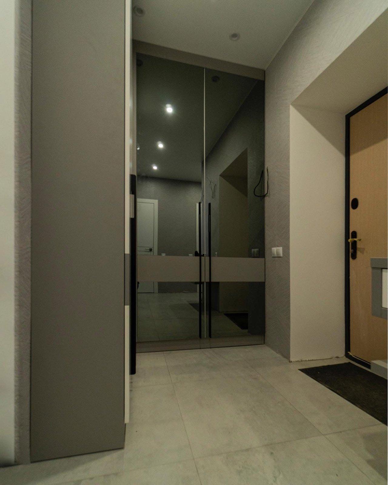 Greige Entryway with Smoked Mirror Wardrobe & Floating Console — 4