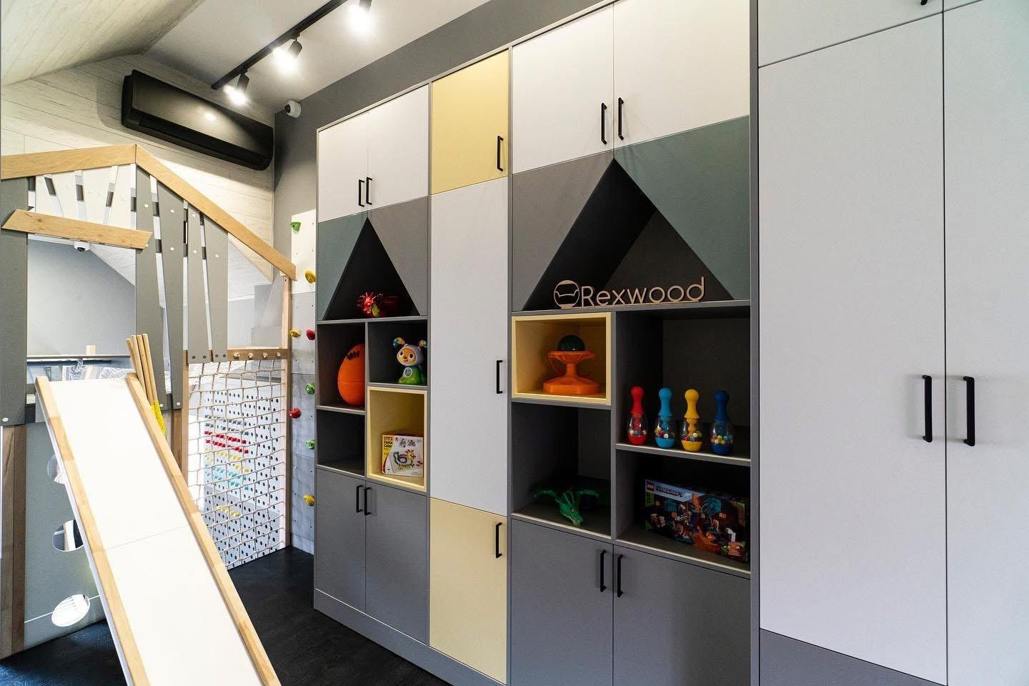 Attic Playroom with House-Shaped Shelving — 7