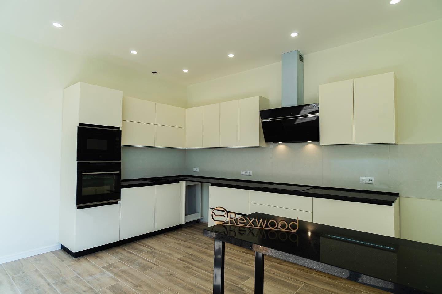 Ivory Handleless L-Shaped Kitchen with Black Worktop & Bar Table — 2