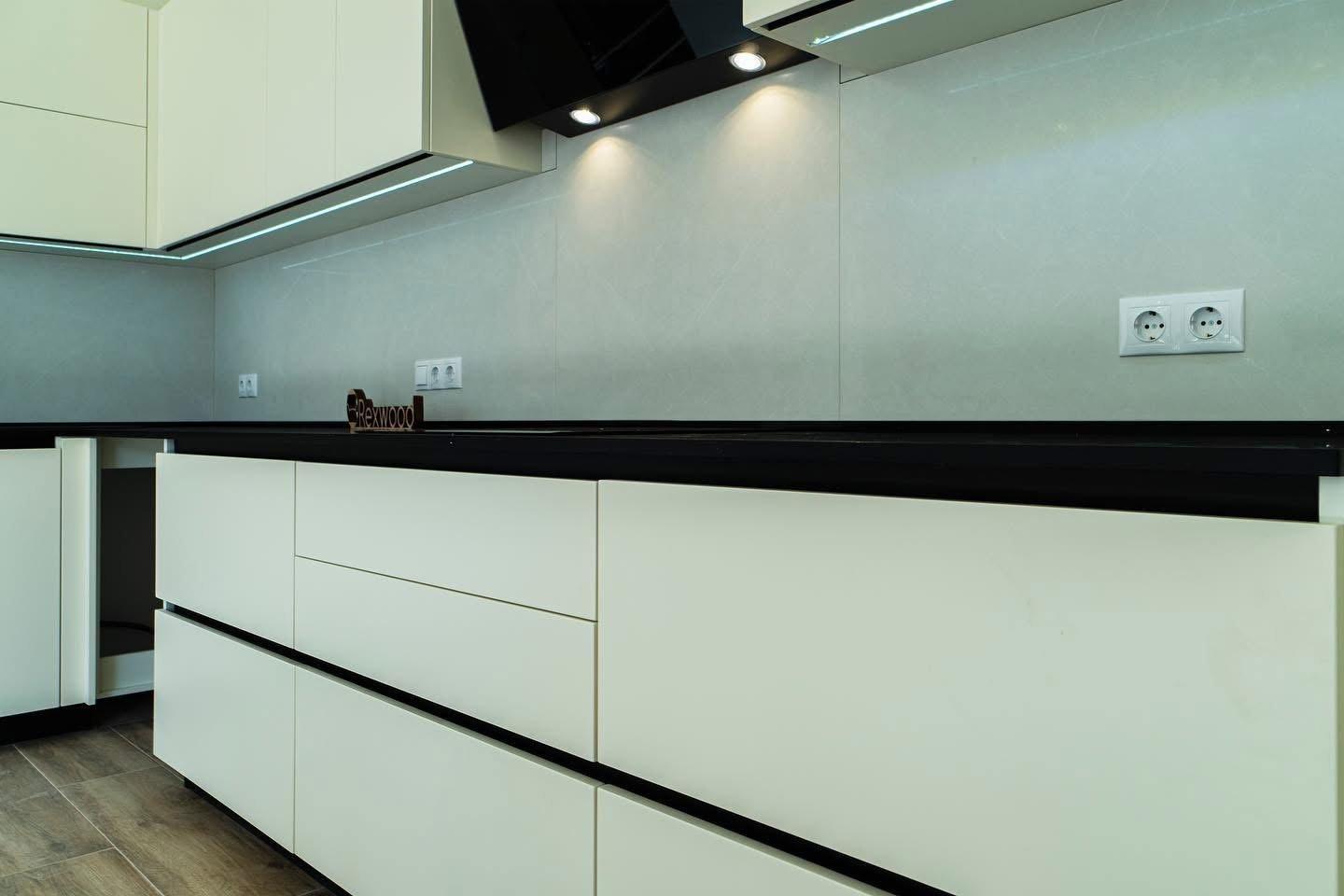 Ivory Handleless L-Shaped Kitchen with Black Worktop & Bar Table — 5