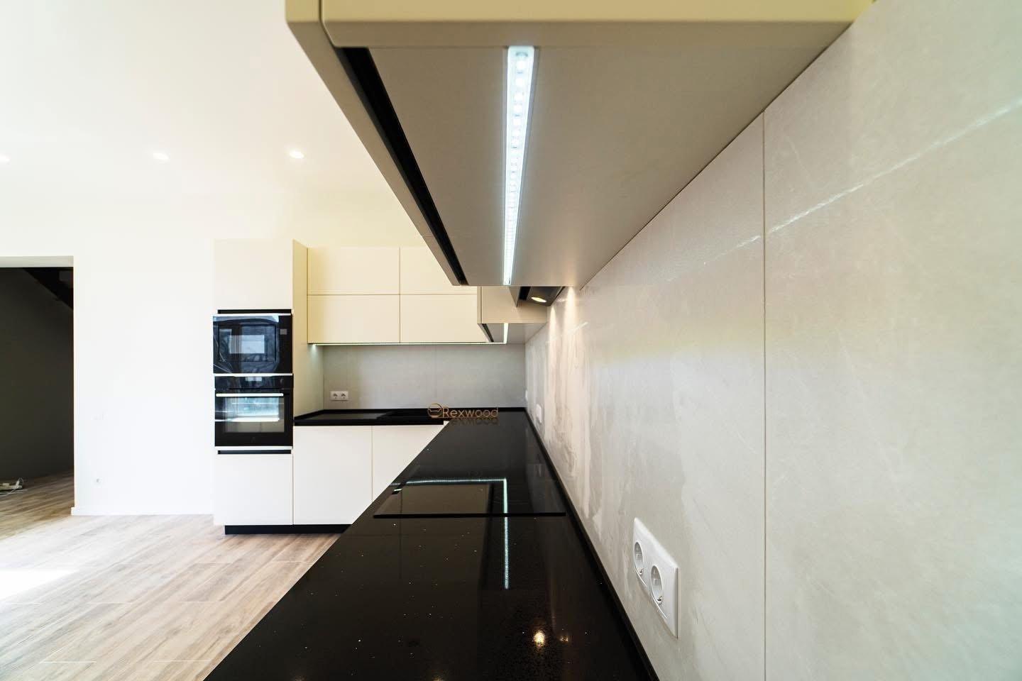Ivory Handleless L-Shaped Kitchen with Black Worktop & Bar Table — 6