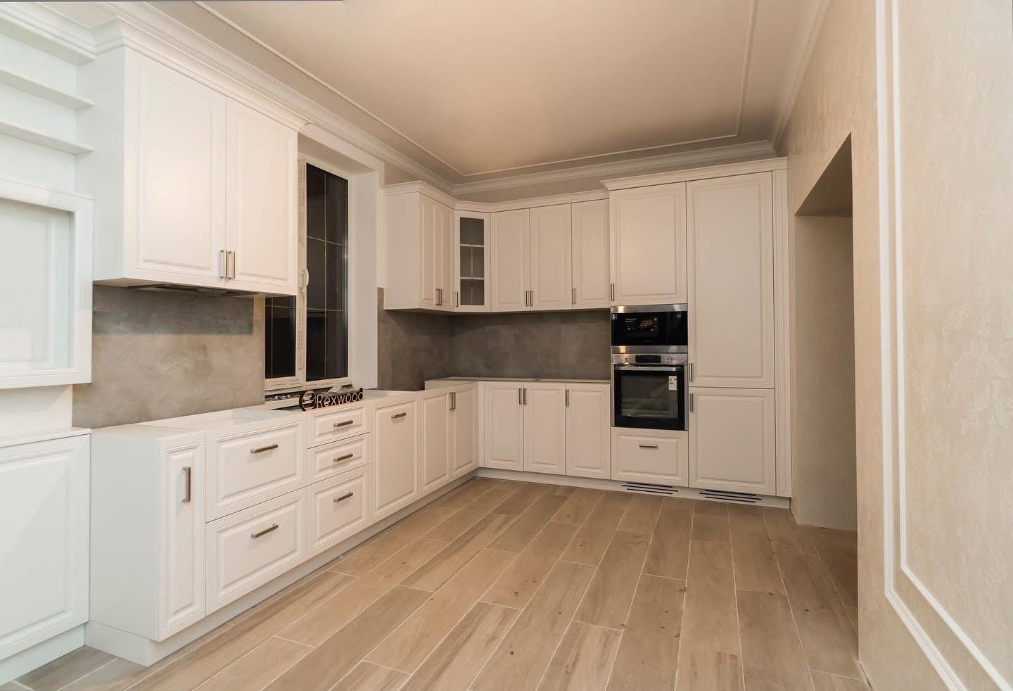 Classic White Kitchen with Leaded-Glass Cabinets & Media Wall