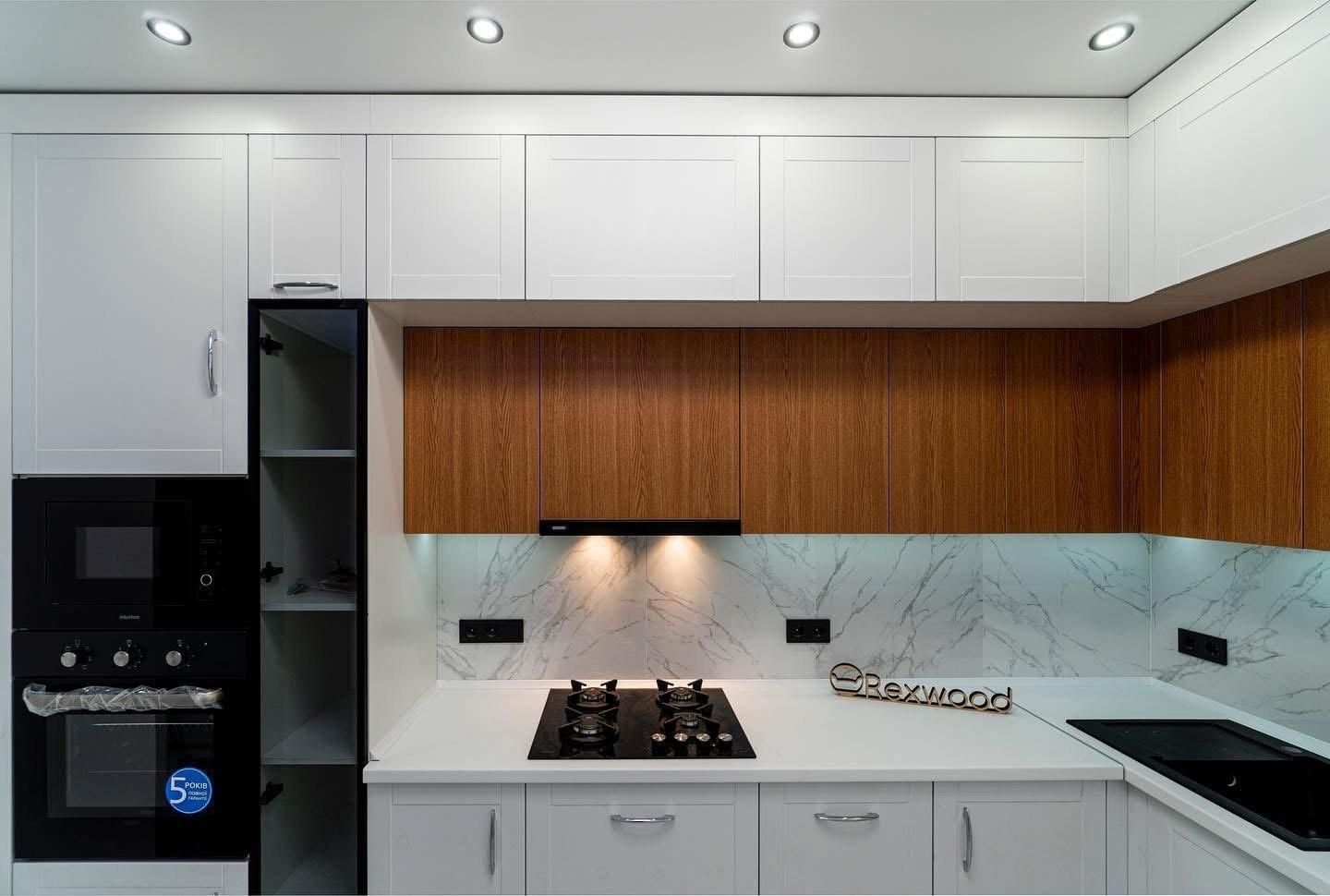 White Shaker & Oak L-Shaped Kitchen with Black-Framed Glass Column — 2